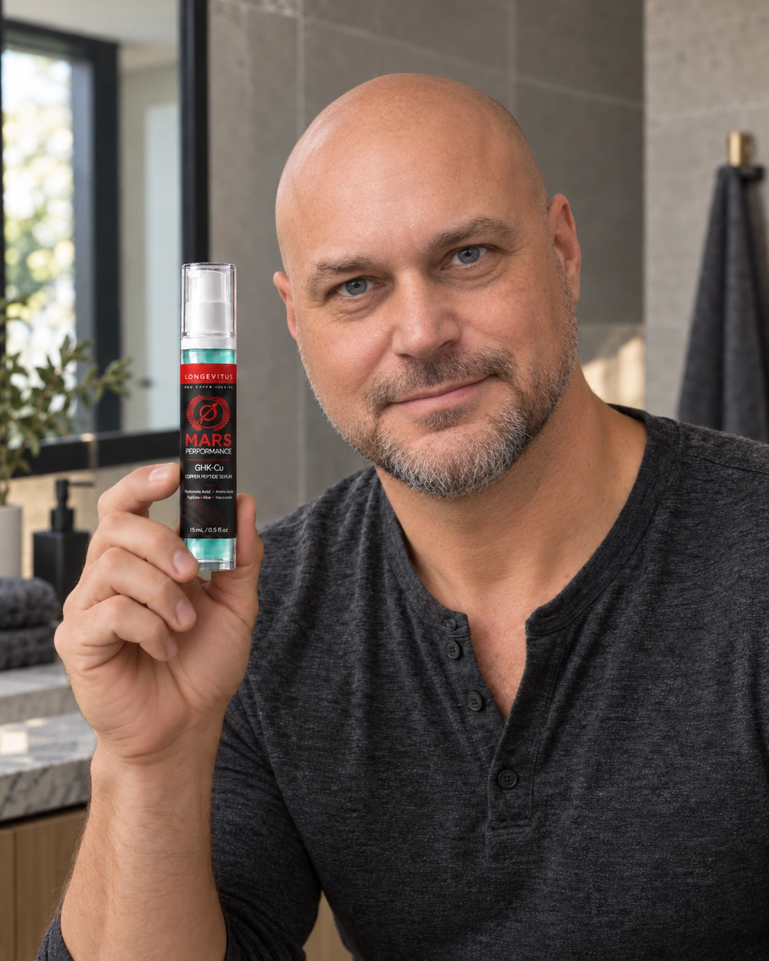 Keith holding a 15 mL Mars Performance GHK-Cu pump bottle in a stone bathroom with soft window light